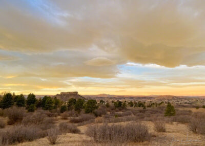 Beautiful Clouds Painted in Warm Yellow Light Form at Sunrise over Castle Rock in the Fall