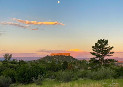 Photo of Full Moon over Castle Rock at Sunrise